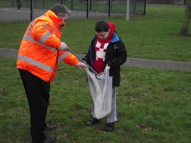 Cllr Garry Hickton is joined by his young son Thomas picking up litter